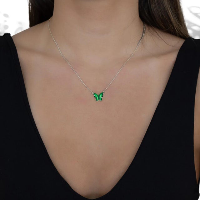 The Silver Abundance Green Enamel Butterfly Necklace, a captivating piece of jewelry that combines the beauty of sterling...