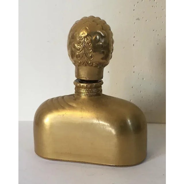 Hattie Carnegie figural perfume bottle. Glass with gold finish. In the form of a figural woman in the Art Deco taste....