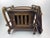 A sculptural French bar/serving cart crafted in solid beech, featuring a removable serving tray and enclosed cabinet...