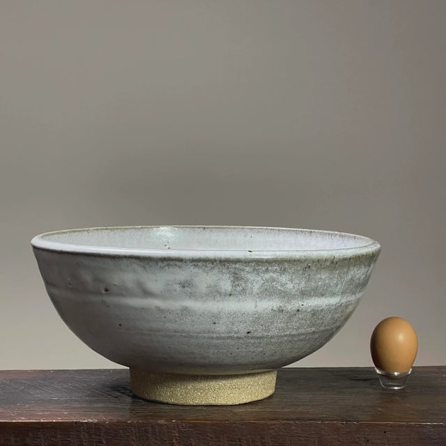 Vintage Minimalist Footed Shino Glazed Stoneware Bowl. Grayish white shino glazed stoneware bowl with unglazed footing. In...