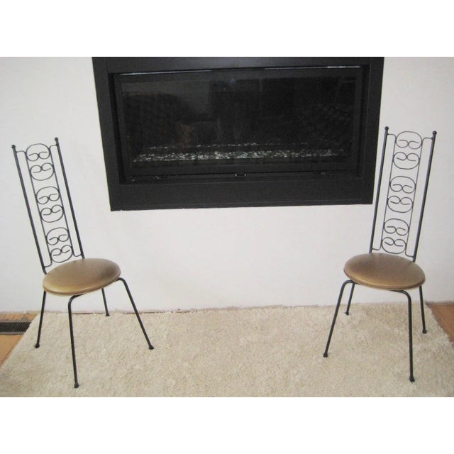 Midcentury pair of black iron Bistro Umanoff Chairs. These chairs have been professionally reupholstered in a beautiful...