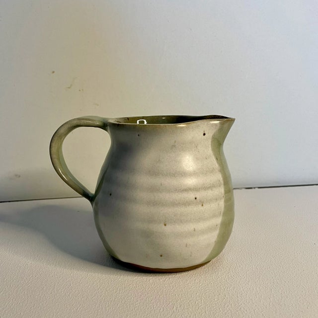 Very cool original piece of pottery handmade by studio artist. Pitcher is signed on the bottom by artist "A Schmidt" and...
