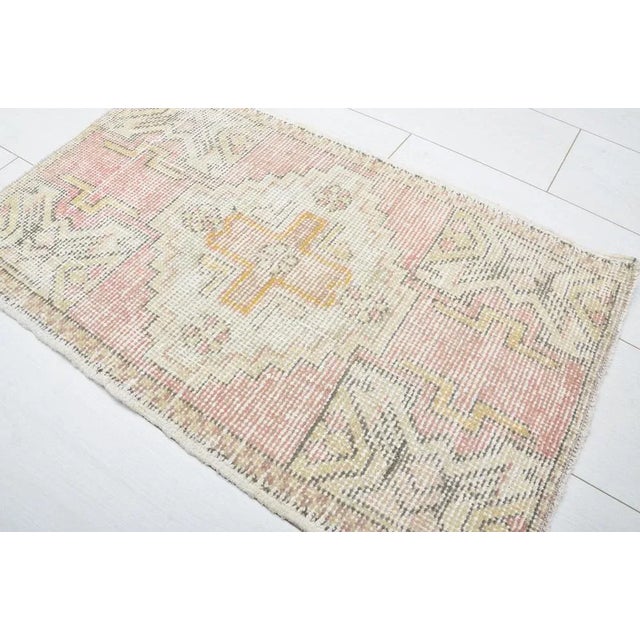 This is a vintage Turkish Oushak rug from the 1960s. The piece was hand-knotted.