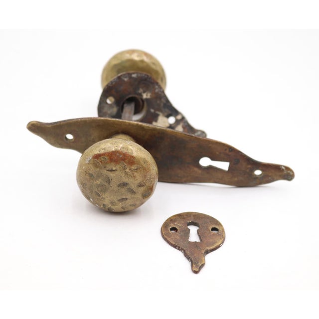 Arts & Crafts style door knob set made of brass with a patina finish. The original mounting screws are not available....