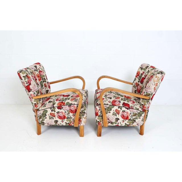 Pair of channeled armchairs with beech frames and floral upholstery. Apparently unmarked but circa 1950s, very similar to...