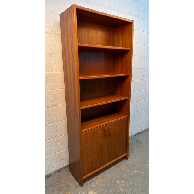 Beautiful vintage Danish teak bookcase and display cabinet with a warm, richly grained teak finish and classic mid-century...
