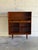 This architectural open shelving unit features an elegant upper display area paired with deep lower cubby storage modules....