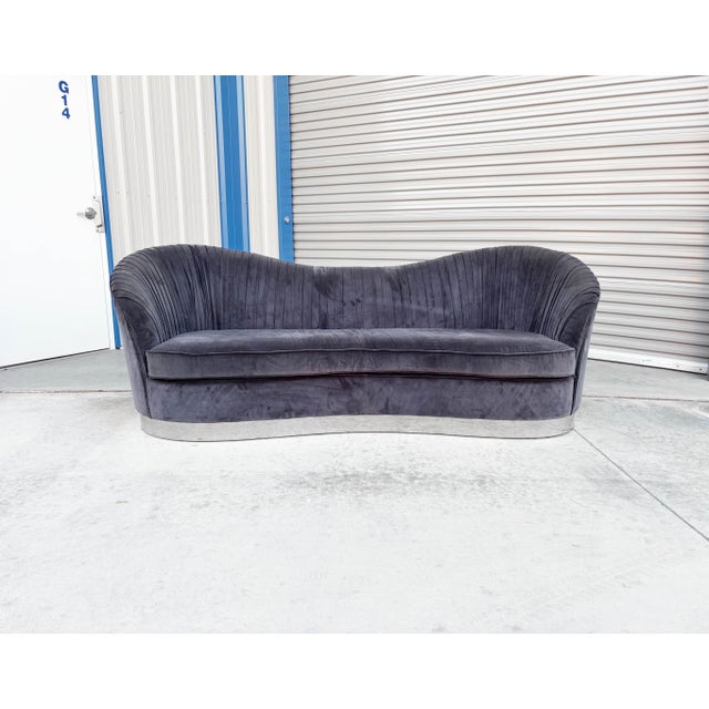 Mid-century chrome curved sofa, designed and manufactured in the United States, circa 1980s. This striking sofa showcases...