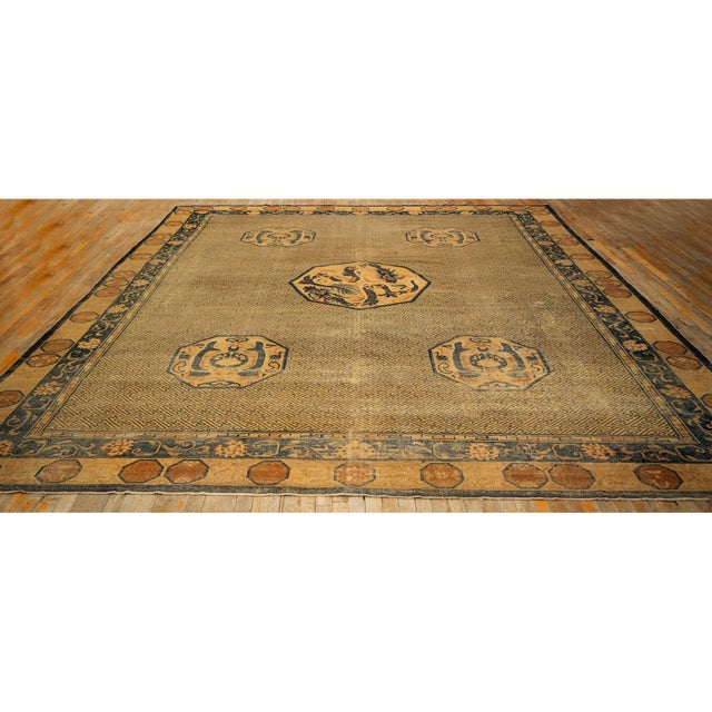 "This is a large antique Chinese wool carpet, circa 1900, measuring approximately 12 by 15 feet. It features a hand-...