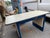 **Description:** Authentic vintage industrial work desk featuring a heavy-duty blue painted steel frame paired with a...