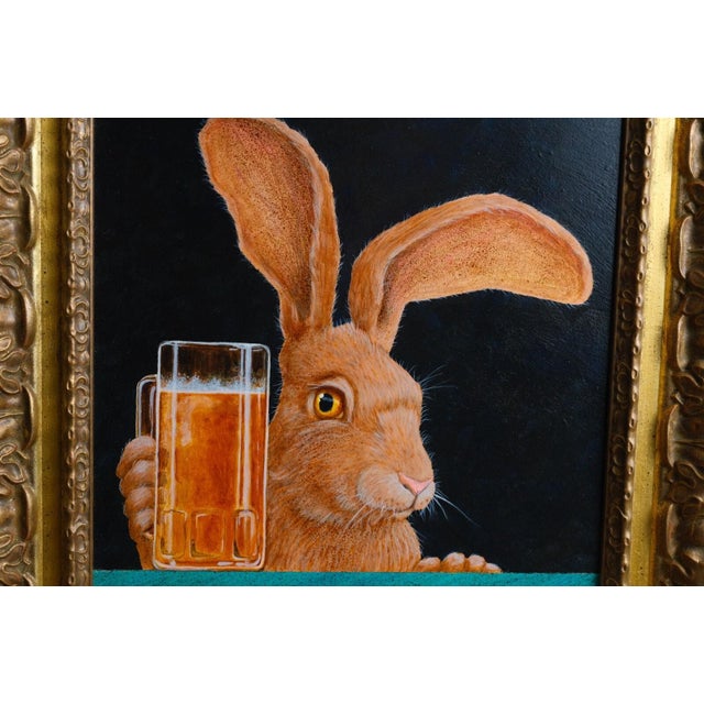 Will Bullas's "Jack with a Beer Back." A long-eared jackrabbit peers over a frosty mug of beer on a turquoise bar top, a...