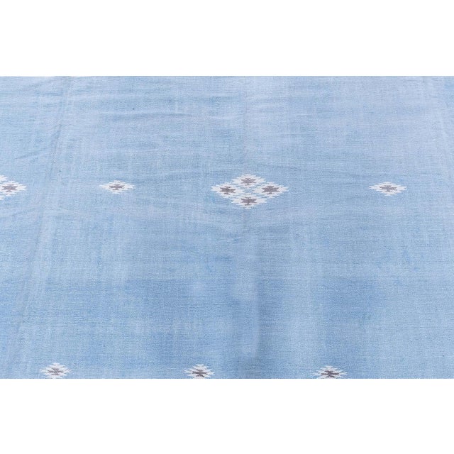 This elegant 1950s Indian Dhurrie rug reflects the refined simplicity and balanced geometry that define many mid-century...