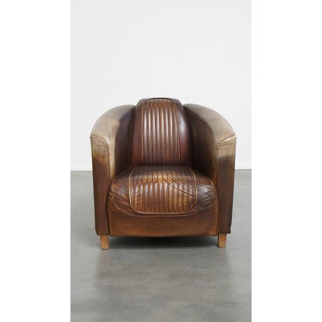 Offered this unique and timeless, exclusive cowhide leather Delta chesterfield Aviator armchair with a beautiful color...