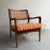 Wonderfully, detailed, Mid-Century Modern, walnut armchair features a caned back and newly upholstered seat cushion in a...