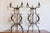 A pair of Italian hand-made wrought-iron plant stands on tripod bases from circa 1900 with scrolling accents. This...