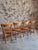 Set of four original French bistro chairs dating from the 1960s. The chairs feature solid beech frames with molded plywood...