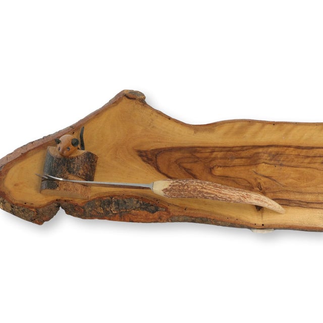 Serve with rustic charm using this unique live edge wood board featuring a whimsical hand-carved mouse tucked into the...