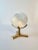 A beautiful ulexite stone sphere, polished and mounted on a brass three prong stand. The sphere casts great light and is...