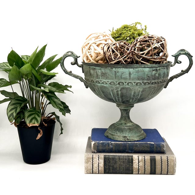 Striking vintage brass urn with beautifully aged verdigris patina, featuring elegant scroll handles, a fluted bowl, and a...