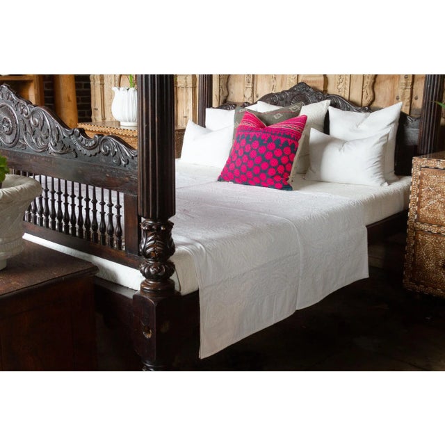 A lightweight cotton coverlet from Western India, beautifully adorned with decorative handcrafted applique cut work using...