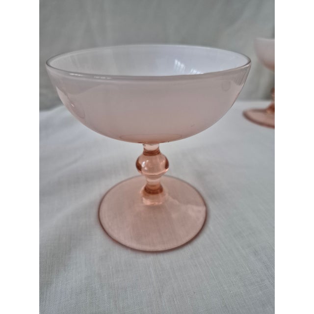 Set of four Carlo Moretti Italian/Murano glass champagne coupes. Bowls are opaque white, stems are pinkish. Circa 1960s....