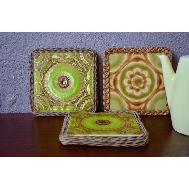 Framed in woven wicker, these pretty seventies ceramic tiles with a psychedelic look and colors make perfect, very...