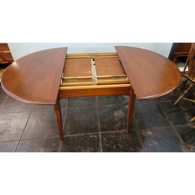 A wonderful Danish Teak Mid -Century Modern dining table. Can be used round or opened with either one or two leaves that...