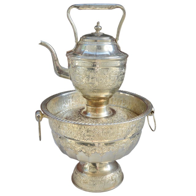 Add a touch of sophistication and a timeless vibe with this remarkable one-of-a-kind antique Moroccan kettle and wash...