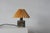 A Danish table lamp with a ceramic base made of glazed stoneware, characteristic of the design style of the Désirée...