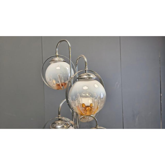 Vintage chrome floor lamp with 6 Murano glass globes, attributed to Mazzega. The lamp emits a nice soft light thanks to...