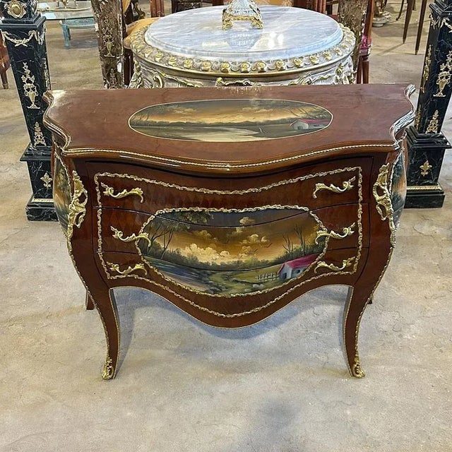 Art stands out in every corner of this commode, it has 3 drawers decorated with gold handles and a beautiful painting. Has...