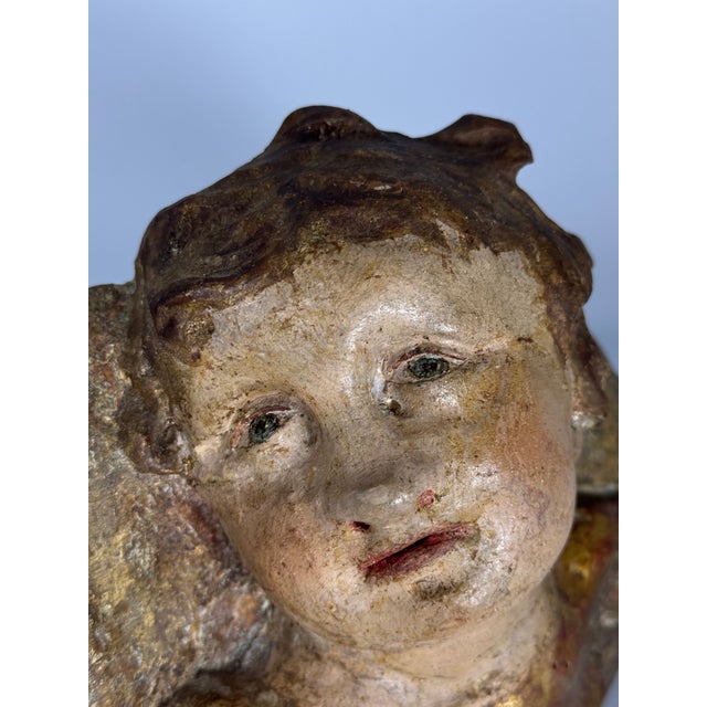 This exquisite 18th-century Spanish polychrome wood angel head is a stunning example of Baroque religious art. Hand-carved...
