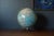 Vintage desk or tabletop globe map with metal atomic stand by George F. Cram Company. This piece rotates on a semi-...