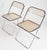 These Giancarlo Piretti for Anonima Castelli Plia Folding Chairs feature a smoky translucent seat and back.