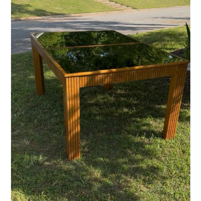 This is a truly one of a kind vintage mid century modern table with original features. The smoked mirrored glass top comes...