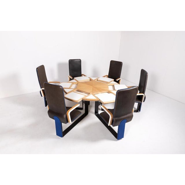 Spectacular Peter Karpf table with 6 fixed armchairs on black lacquered metal frame. Table top can be rotated and white...
