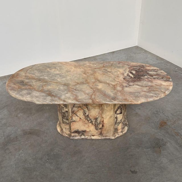 A striking vintage italian coffee table crafted entirely in fior di pesco marble, celebrated for its extraordinary natural...