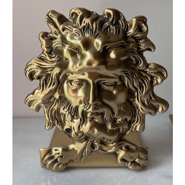 These bookends are designed in the Louis XIV or Hollywood Regency style, featuring a mythological male face adorned with a...