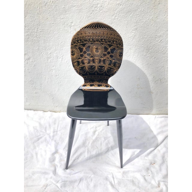 Piero Fornasetti lithographed wood and painted metal side chair.