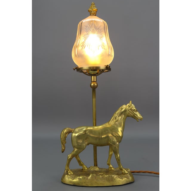French bronze and cut frosted glass table lamp with a horse, from circa the 1950s. A beautiful and heavy French bronze...