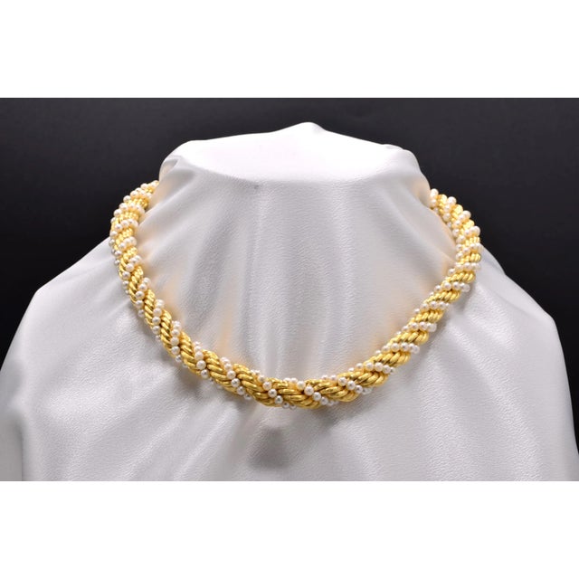 The 52nd Street: Classic Pearl and Rope Chain Woven Necklace in Yellow Gold. This exquisite necklace boasts a secure push...