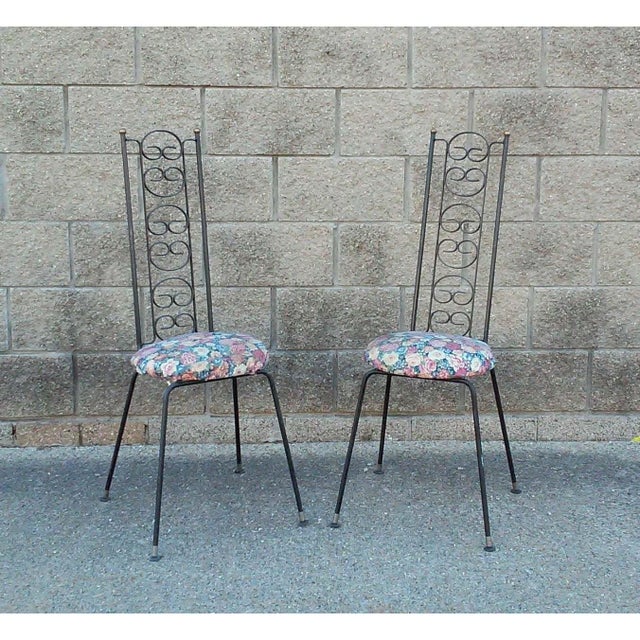 A pair of Mid Century Modern high back iron chairs designed by Arthur Umanoff. for The Grenada Collection. The chairs have...