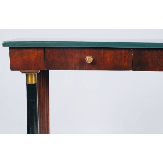 A striking Empire Revival console table distinguished by its architectural form, elegant proportions, and sophisticated...
