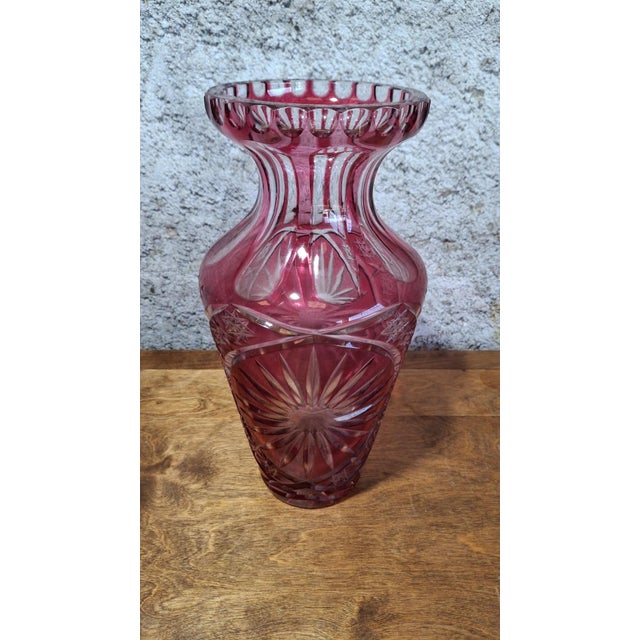 Large red overlay crystal vase, with a slender baluster shape and a strongly constricted neck surmounted by a flat, flared...