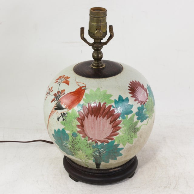 This antique table lamp is made with an authentic white porcelain vase featuring a vibrant Famille Rose palette. The...