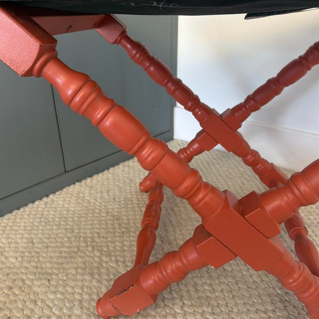 Charming coral/orange turned wood cross-based stool with simple stripe upholstery made in Italy by Buying & Design SRL....