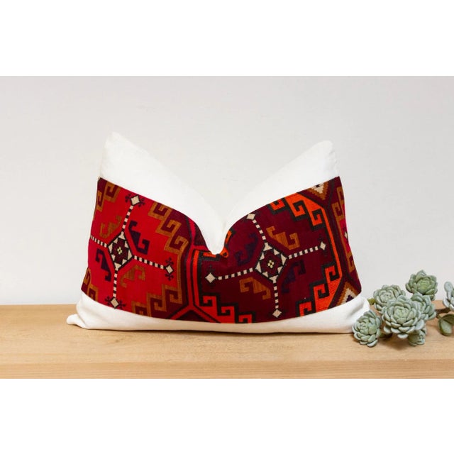 This handcrafted pillow features a vibrant, hand-stitched textile created by the Lakai tribe of Uzbekistan. It is a unique...