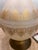 A showstopper of a lamp. This vintage frosted glass table lamp features an elegant genie bottle silhouette with hand-...