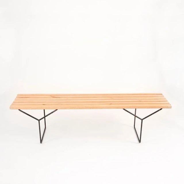 A beautiful modernist ashwood slat bench with an iron base from the 1950s. Designed by Harry Bertoia for Knoll. Restored,...