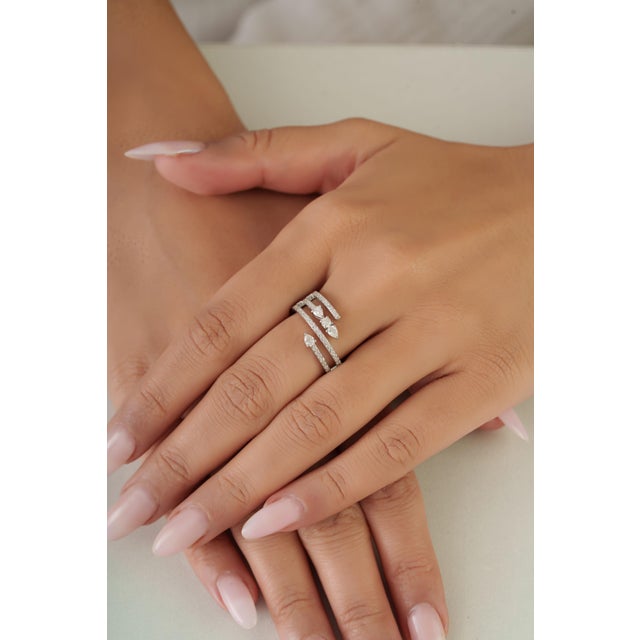 This bypass wrap ring features 0.62 carats of mixed-cut diamond set, in a 14k white gold. Each secure in a channel...